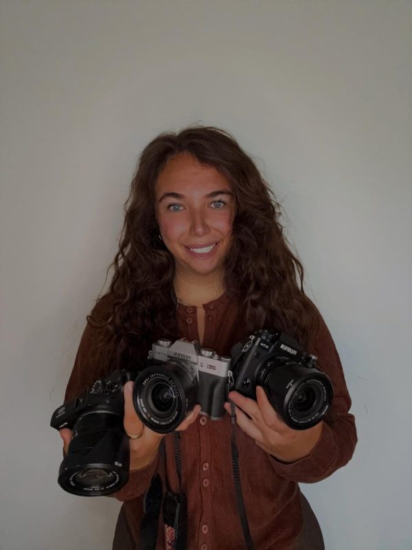  Milena Rudan, photographer, smiling and holding three Fujifilm cameras